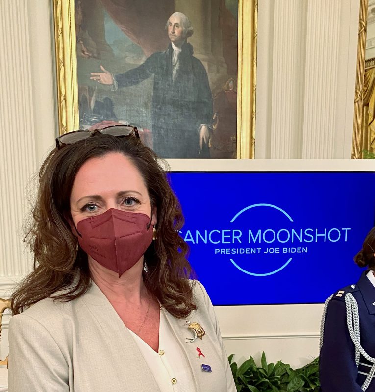 YSC CEO Jennifer Merschdorf standing in front of Cancer Moonshot sign